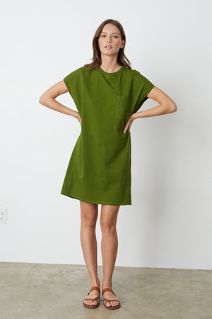 a model wearing a green Velvet by Graham & Spencer Cassidy Crew Neck Dress and sandals.