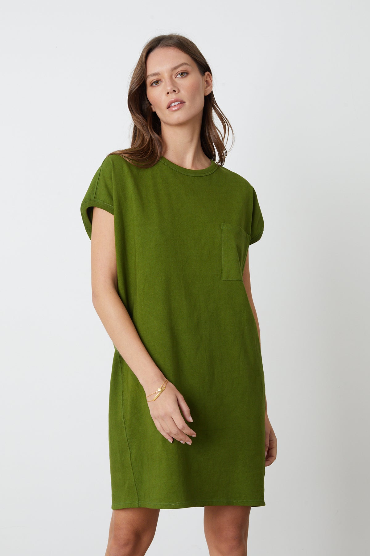   a model wearing a green Cassidy Crew Neck Dress by Velvet by Graham & Spencer. 
