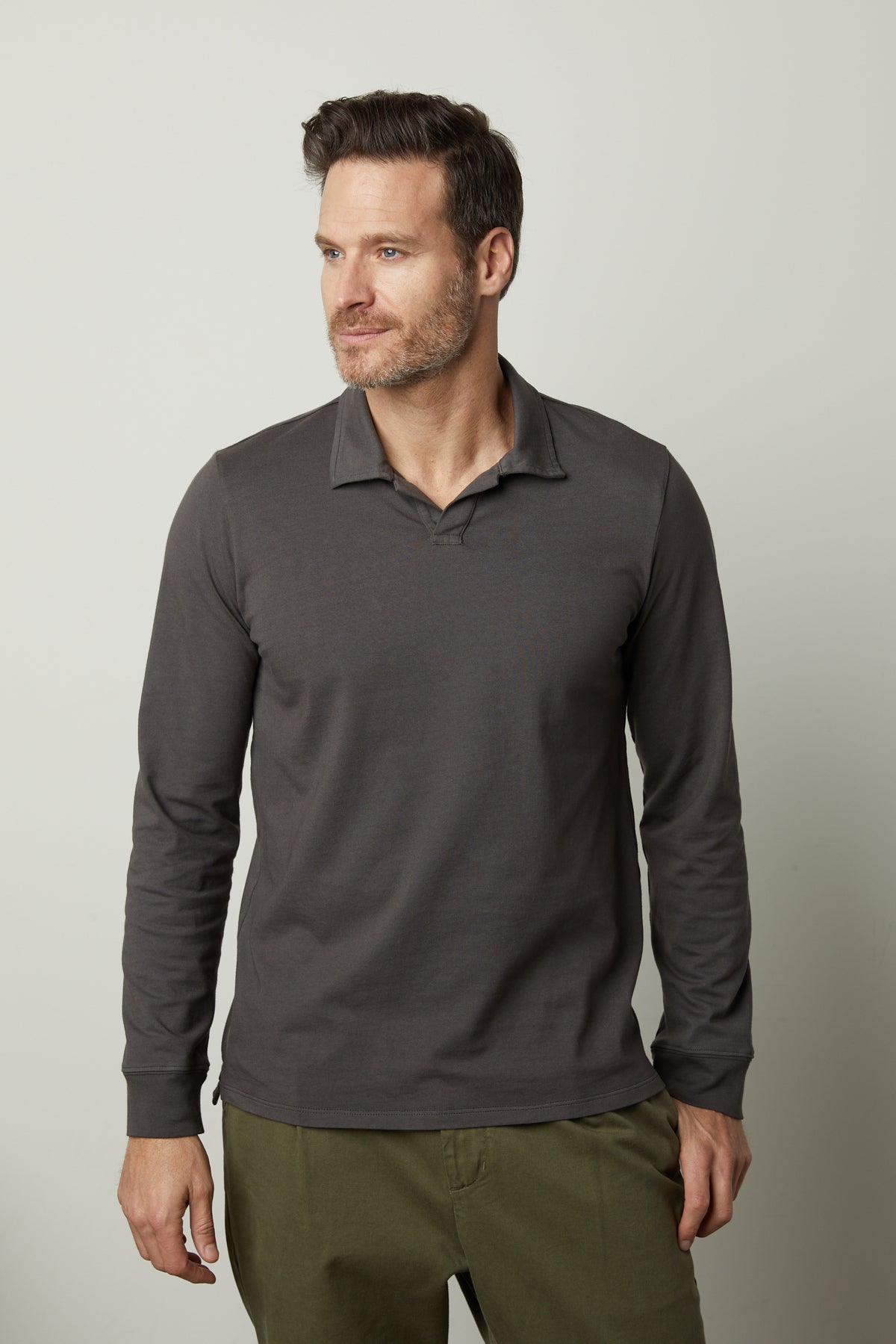 A man wearing a grey long sleeved KOLBE POLO shirt by Velvet by Graham & Spencer.-26827672027329