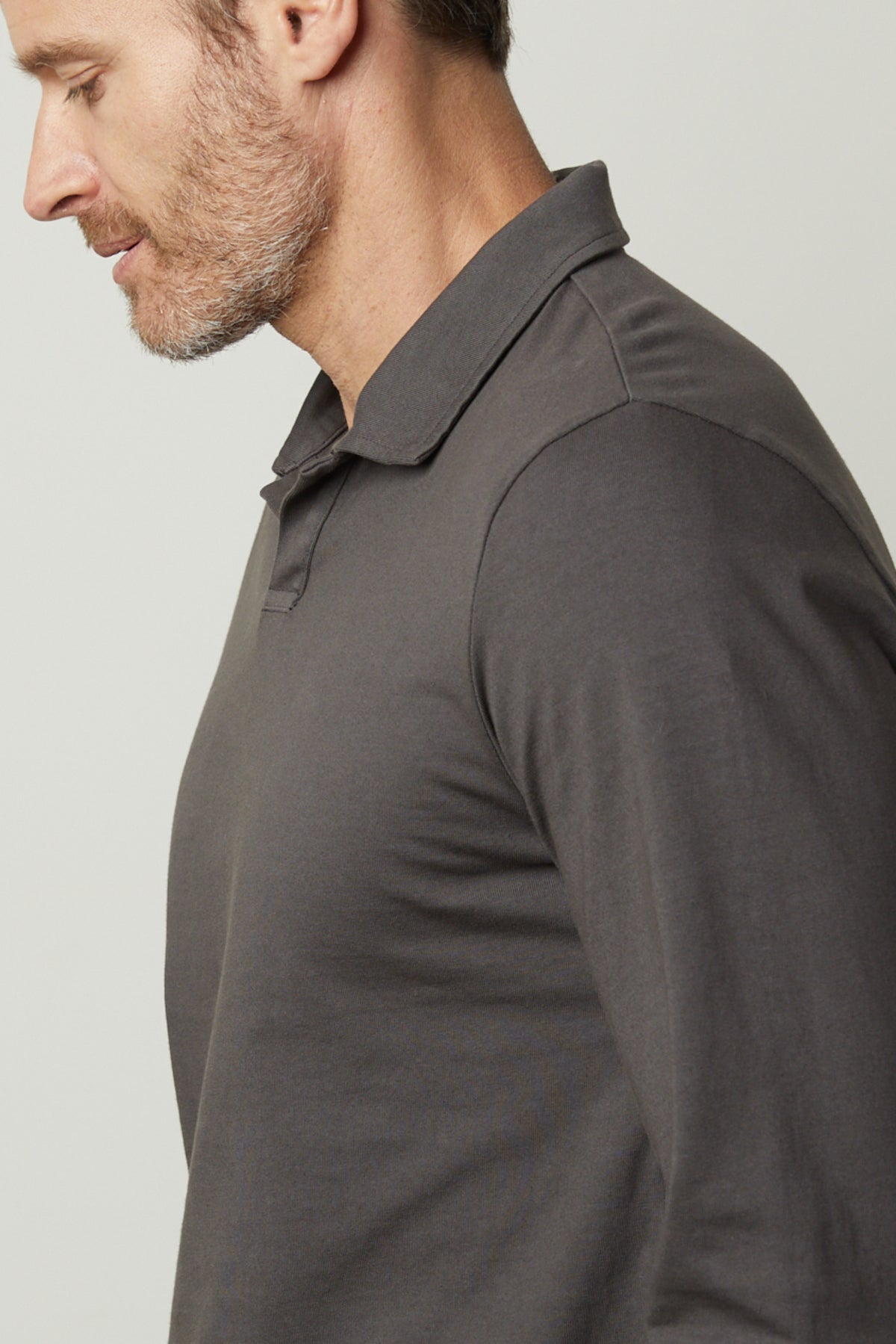 A man wearing a grey long-sleeved Velvet by Graham & Spencer Kolbe Polo shirt.-26827672125633