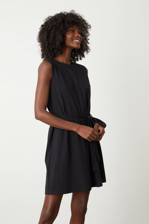 a woman wearing a Velvet by Graham & Spencer LAINE STRUCTURED TANK DRESS with a belt.
