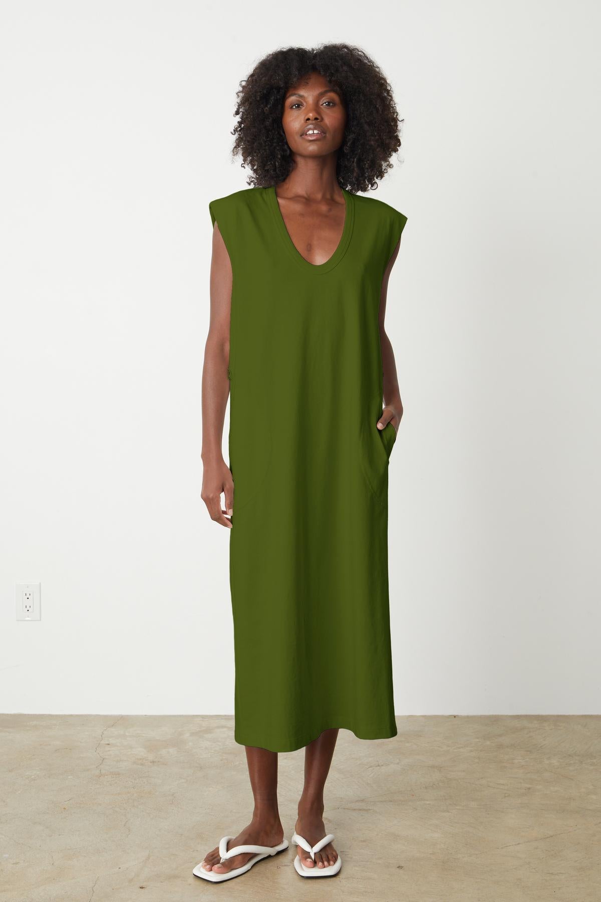 A woman wearing a structured cotton MACI SCOOP NECK DRESS by Velvet by Graham & Spencer showcasing versatility.-35201180401857
