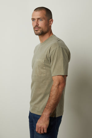 A man wearing a NEPTUNE CREW NECK POCKET TEE by Velvet by Graham & Spencer and jeans.