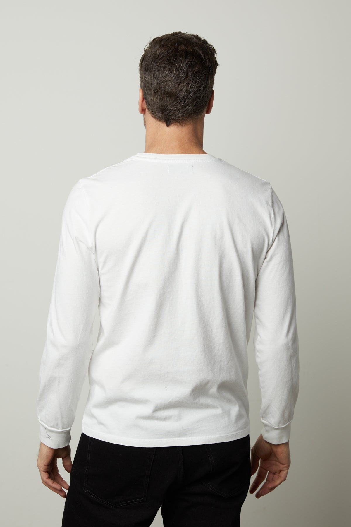   The back view of a man wearing a Velvet by Graham & Spencer REMI HENLEY t - shirt. 