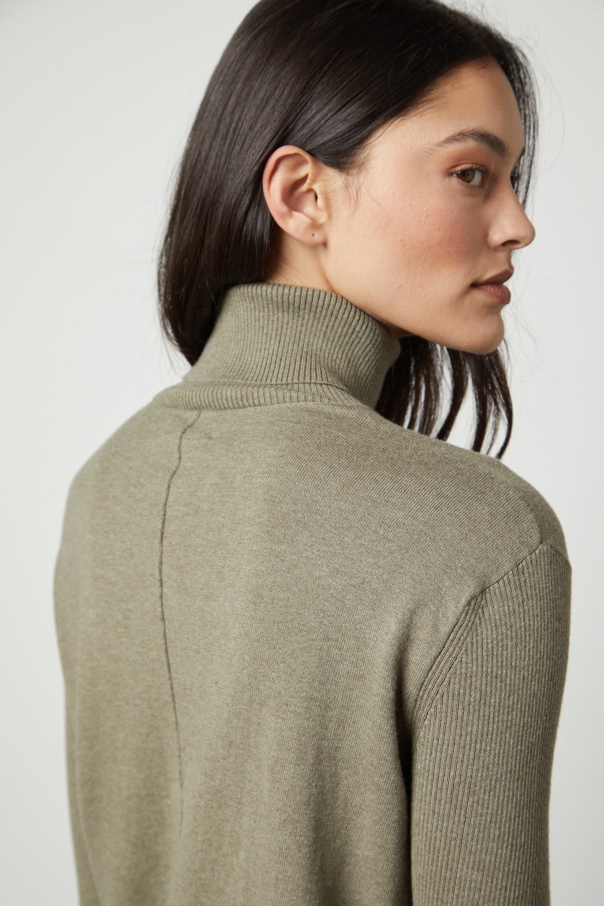 The back view of a woman wearing a Velvet by Graham & Spencer SALLY MOCK NECK SWEATER.-35503516057793