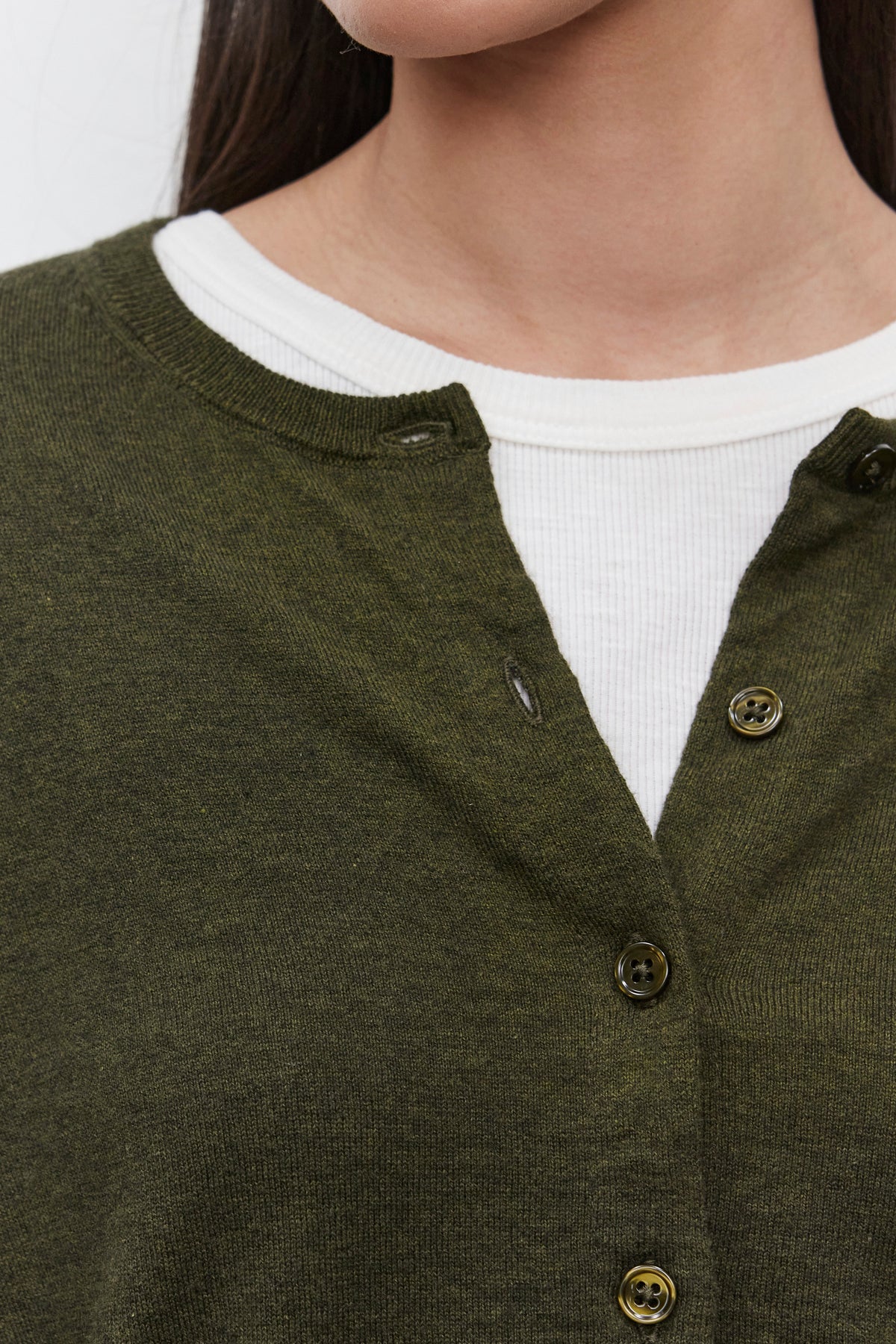   Close-up of a woman's upper torso wearing the VIOLETTE CARDIGAN by Velvet by Graham & Spencer, with a lux cotton cashmere white ribbed shirt underneath. 