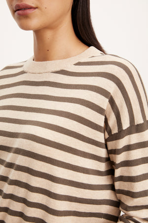 The model is wearing a ALISTER STRIPED CREW NECK SWEATER by Velvet by Graham & Spencer.