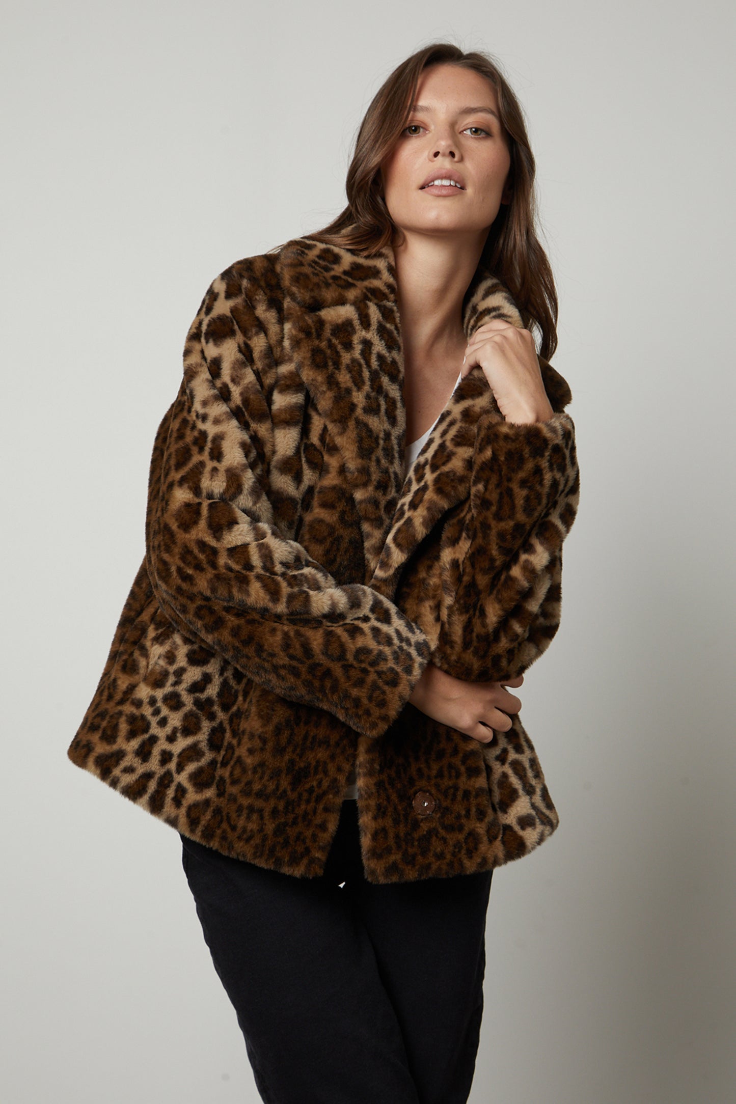 A woman wearing the AMANI LEOPARD LUX faux fur jacket from Velvet by Graham & Spencer made from faux fur fabric.-35626120741057