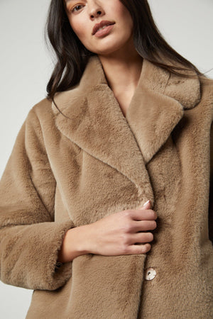 A model wearing a RAQUEL FAUX LUX FUR JACKET by Velvet by Graham & Spencer.