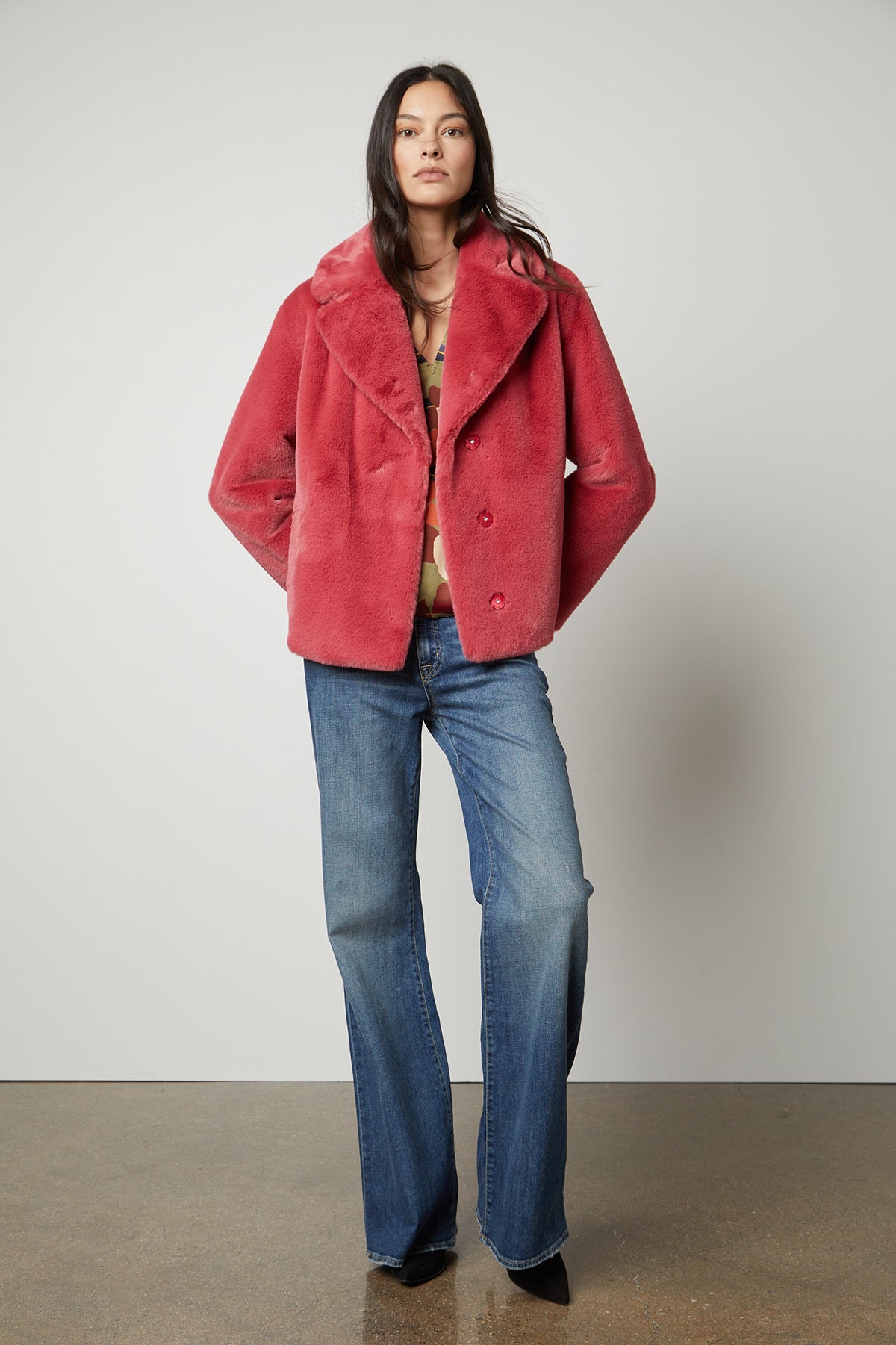   The model is looking chic in a pink Velvet by Graham & Spencer RAQUEL FAUX LUX FUR JACKET, perfect for the cold weather. 