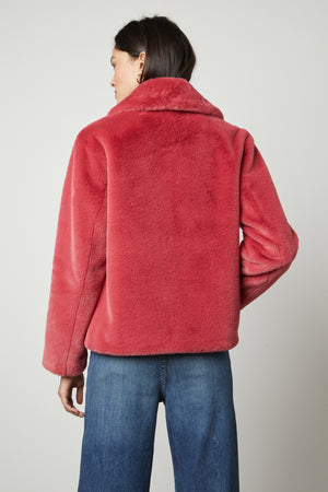 The back view of a woman wearing a Velvet by Graham & Spencer Raquel Faux Lux Fur Jacket.