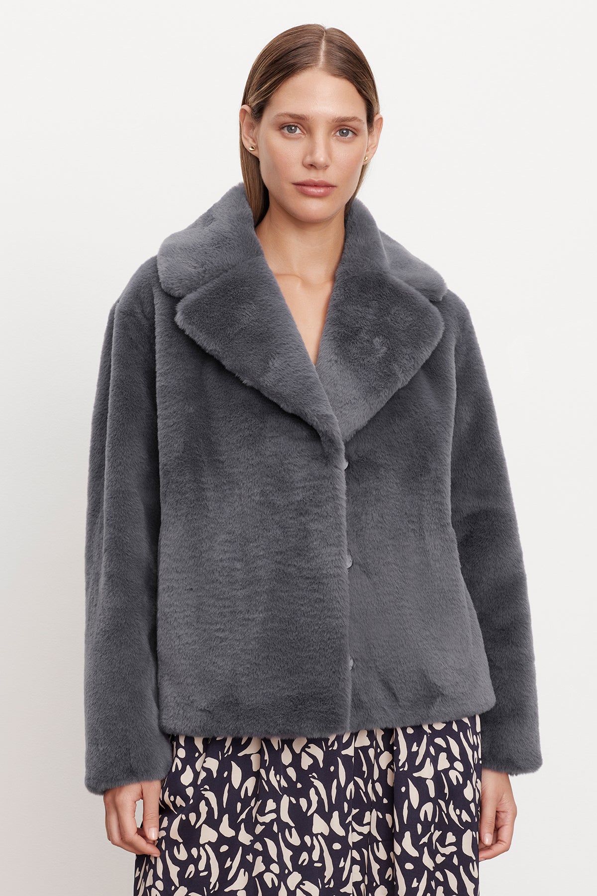   A woman wearing a grey Velvet by Graham & Spencer Raquel Faux Lux Fur Jacket. 