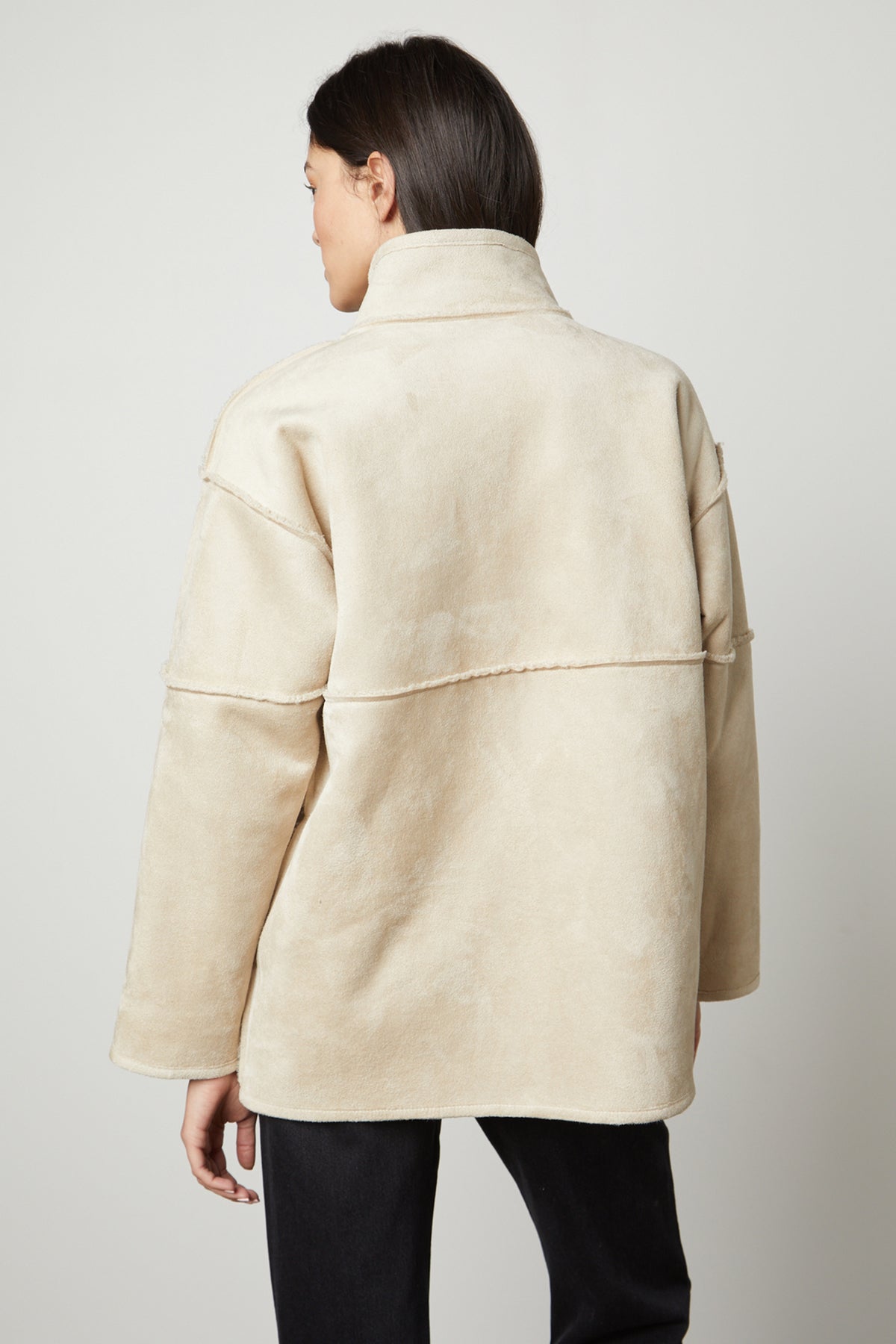 The back view of a woman wearing an ALBANY LUX SHERPA REVERSIBLE JACKET made by Velvet by Graham & Spencer.-35782611173569