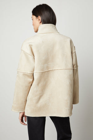 The back view of a woman wearing an ALBANY LUX SHERPA REVERSIBLE JACKET made by Velvet by Graham & Spencer.