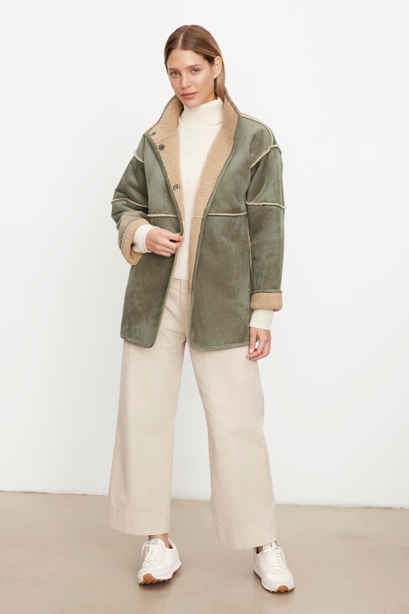 The model is wearing a Velvet by Graham & Spencer ALBANY LUX SHERPA REVERSIBLE JACKET.