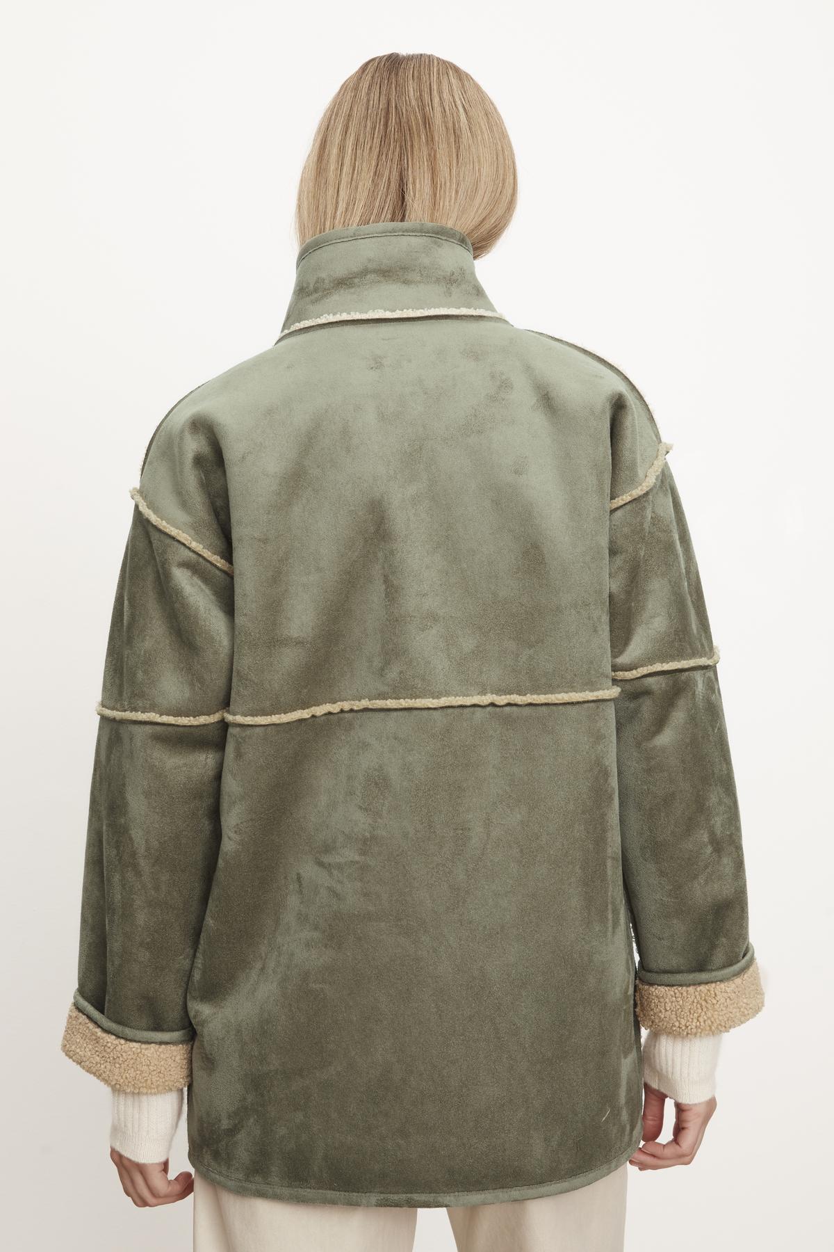   The back view of a woman wearing an Albany Lux Sherpa Reversible Jacket by Velvet by Graham & Spencer. 