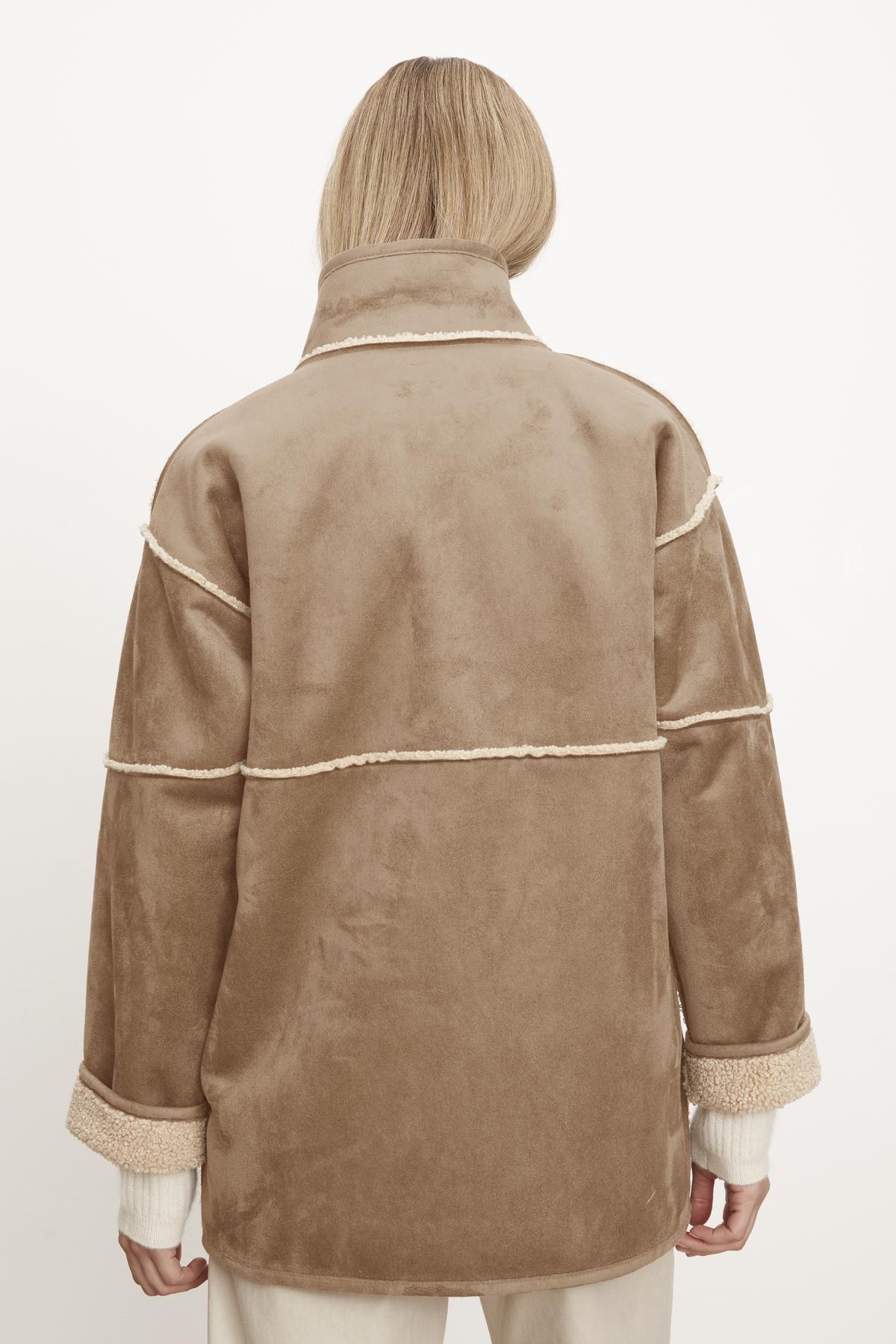 The back view of a woman wearing a Velvet by Graham & Spencer ALBANY LUX SHERPA REVERSIBLE JACKET.-35782611599553