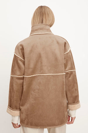 The back view of a woman wearing a Velvet by Graham & Spencer ALBANY LUX SHERPA REVERSIBLE JACKET.
