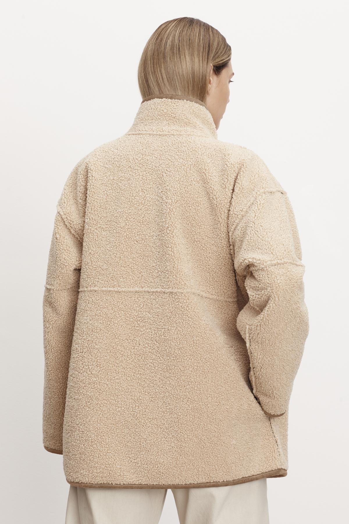   The relaxed silhouette of a woman wearing the ALBANY LUX SHERPA REVERSIBLE JACKET from Velvet by Graham & Spencer. 