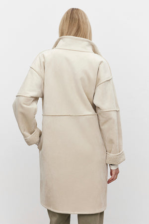 A person wearing a Velvet by Graham & Spencer CARA LUXE SHERPA REVERSIBLE JACKET in cream-colored faux suede with a high collar, viewed from the back against a plain white background.