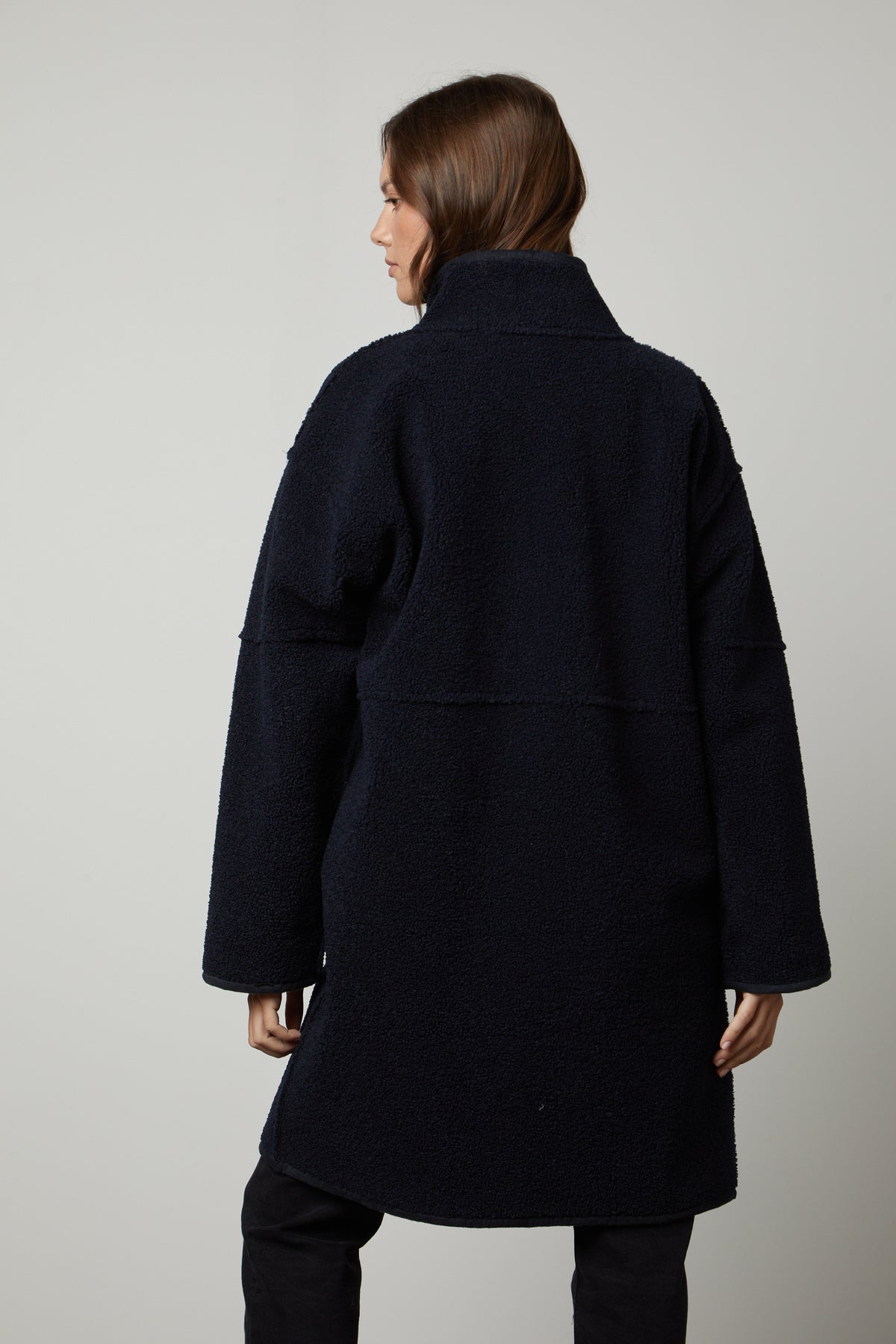 The back view of a woman wearing a Velvet by Graham & Spencer CARA LUX SHERPA REVERSIBLE JACKET.-26897578852545