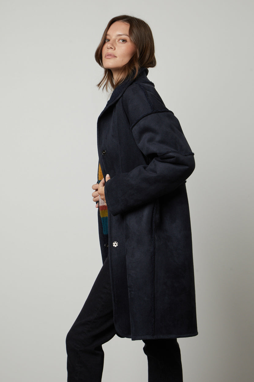 The model is wearing a Velvet by Graham & Spencer CARA LUX SHERPA REVERSIBLE JACKET and jeans.