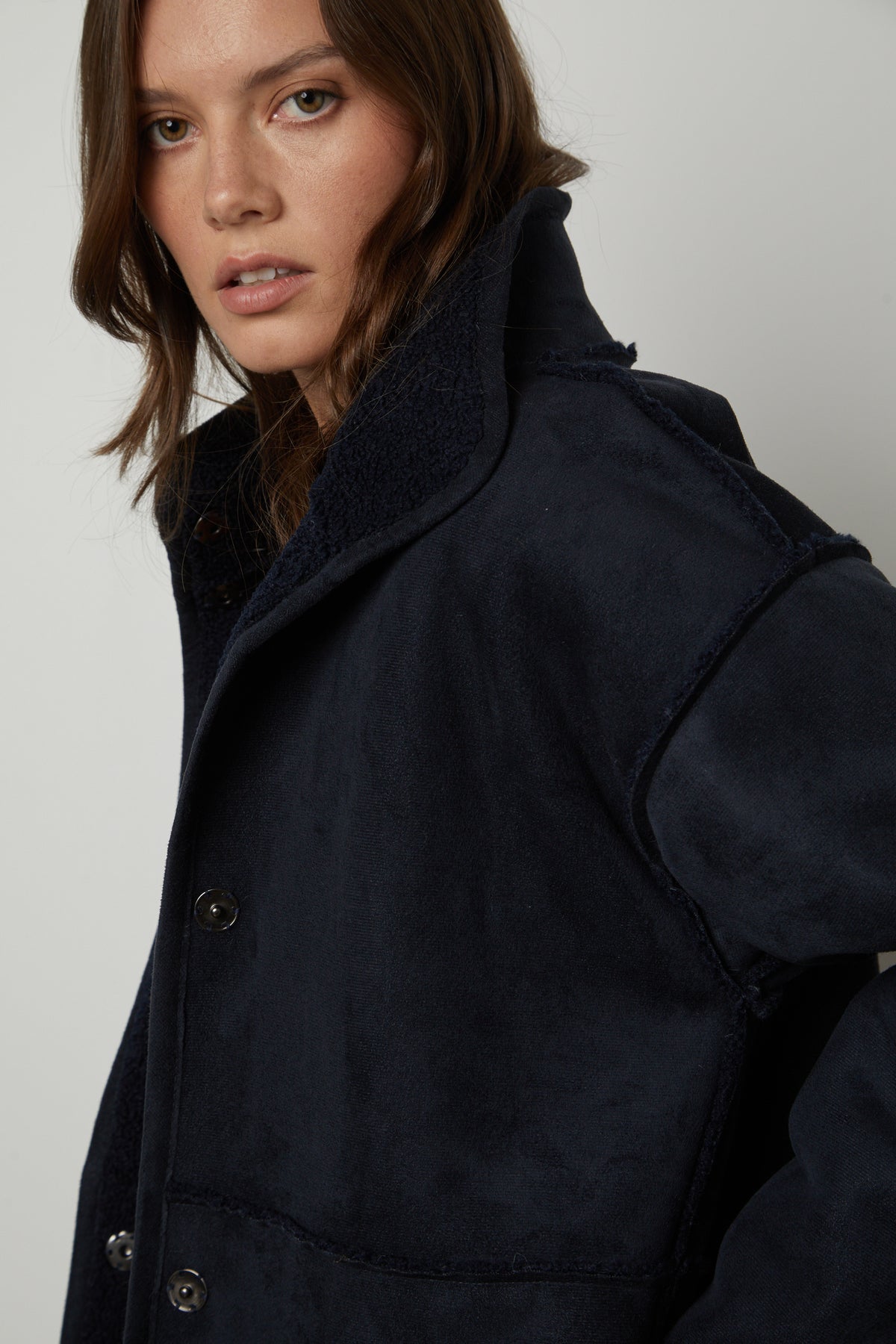   The model is wearing a Velvet by Graham & Spencer CARA LUX SHERPA REVERSIBLE JACKET. 