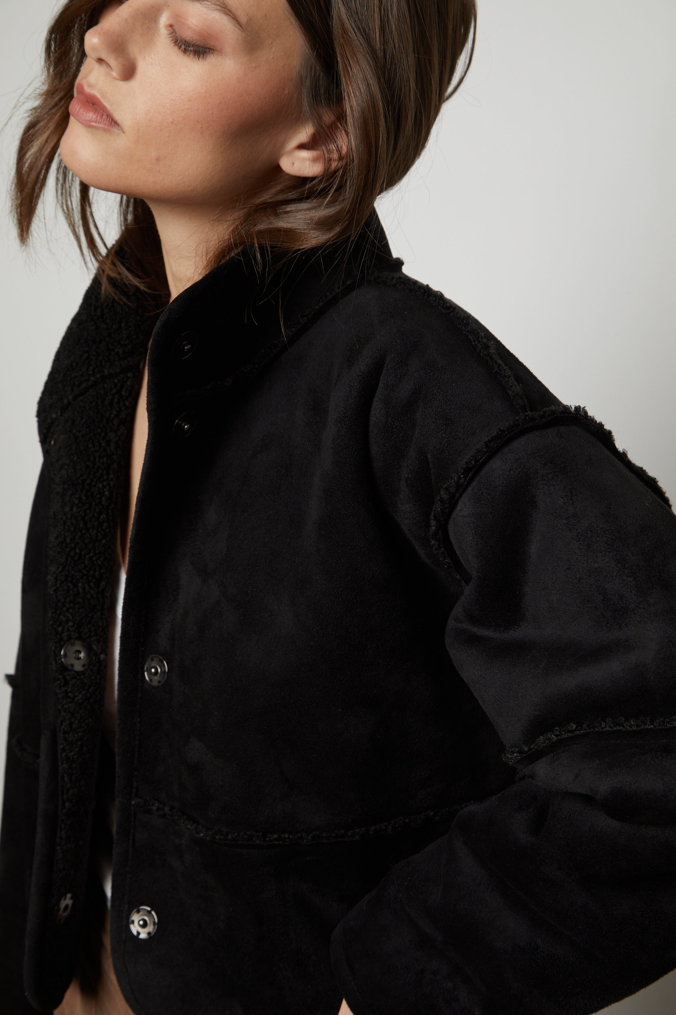   The model is wearing a Velvet by Graham & Spencer KELLY LUX SHERPA REVERSIBLE JACKET. 