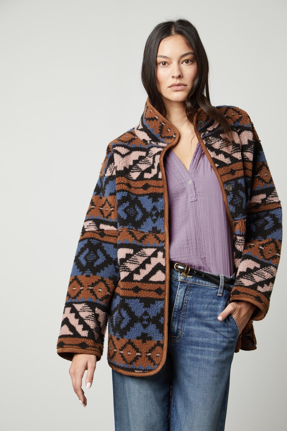 A woman wearing a cozy Velvet by Graham & Spencer LAILA PRINTED SHERPA REVERSIBLE JACKET.-35416298913985