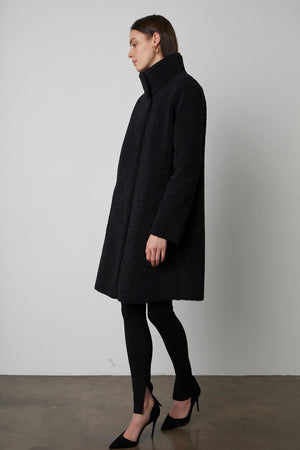 Mirabel Faux Lux Sherpa Reversible Coat in black with black leggings and black heels full length front & side view
