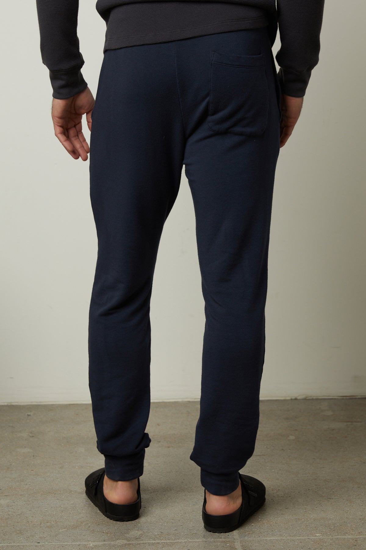 The back view of a man wearing Velvet by Graham & Spencer's CROSBY LUXE FLEECE JOGGER, perfect for workouts.-35662741242049