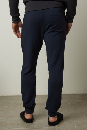 The back view of a man wearing Velvet by Graham & Spencer's CROSBY LUXE FLEECE JOGGER, perfect for workouts.
