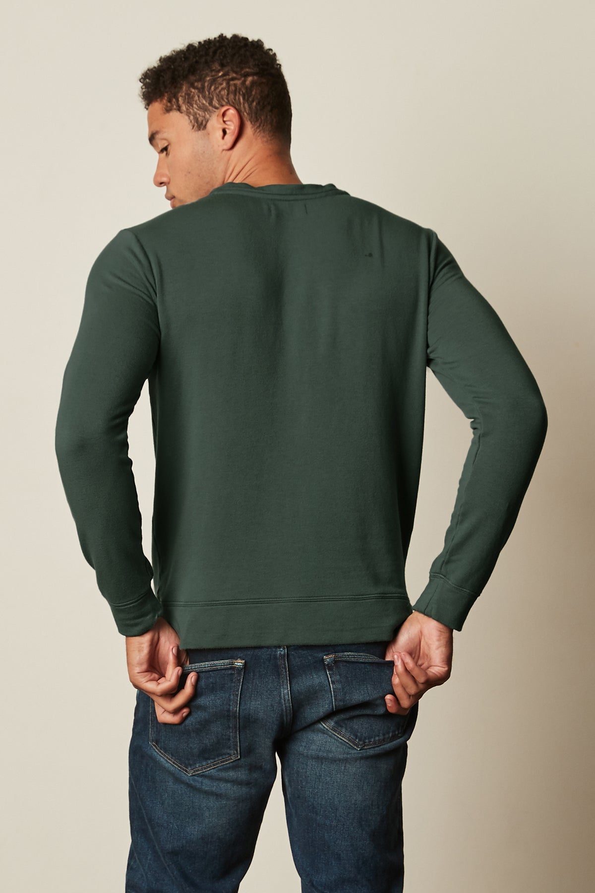 The back view of a man wearing a Velvet by Graham & Spencer SOREN LUXE FLEECE PULLOVER and jeans.-26632270020801