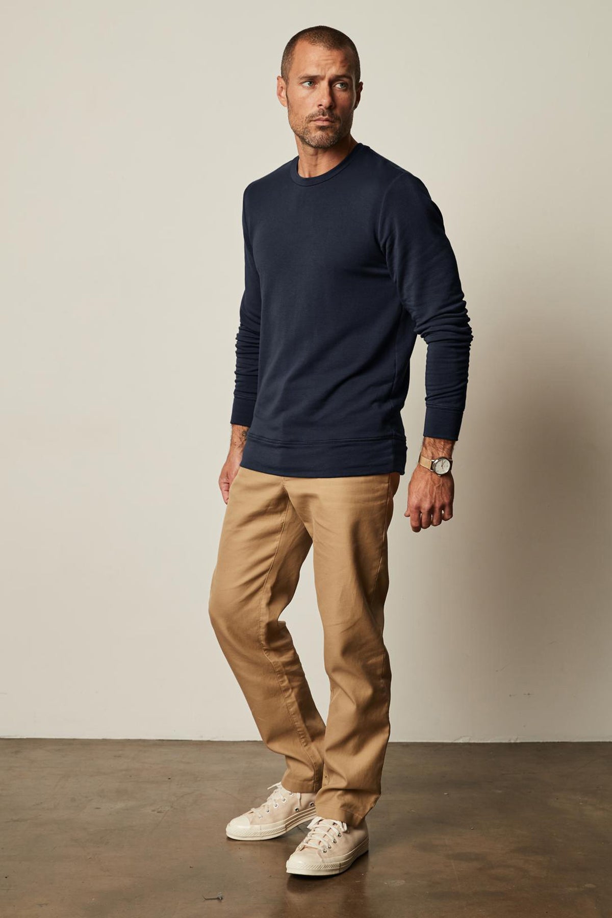 A man wearing a Velvet by Graham & Spencer SOREN LUXE FLEECE PULLOVER navy sweatshirt.-35662615675073