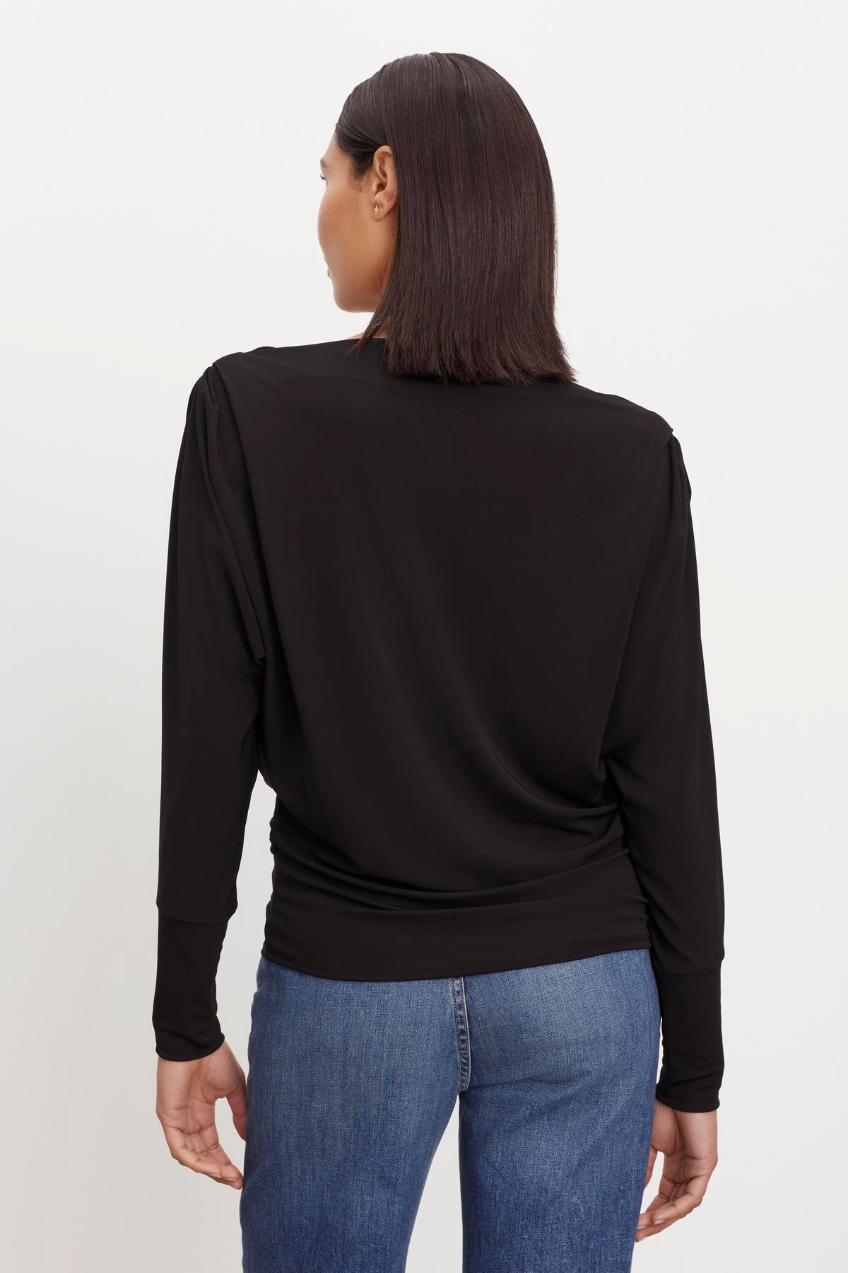   The back view of a woman wearing a Velvet by Graham & Spencer BESS BOATNECK TOP. 