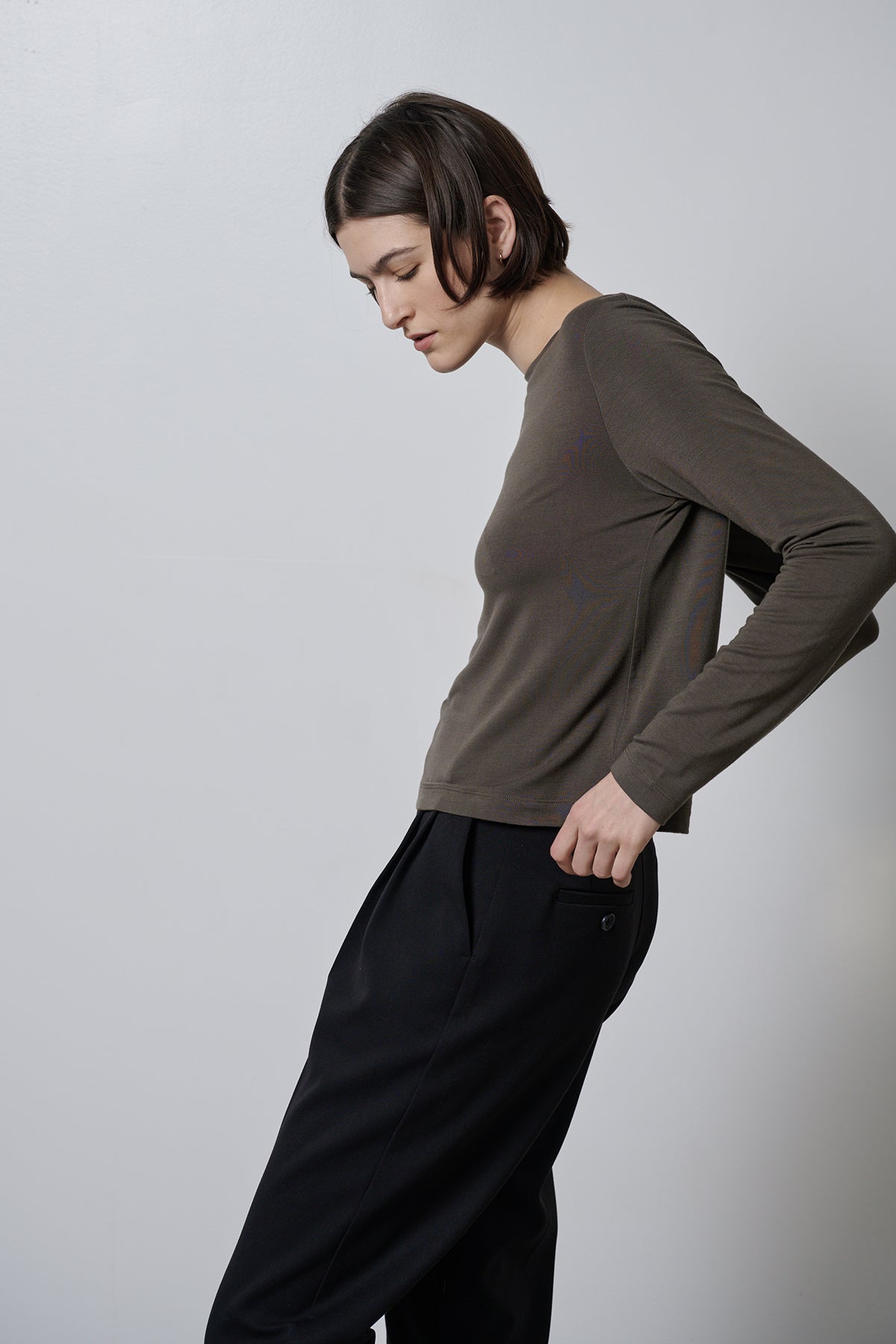 A woman wearing black trousers made of rib knit fabric and a Velvet by Jenny Graham long-sleeved Pacifica Tee with a soft hand feel.-35416710250689