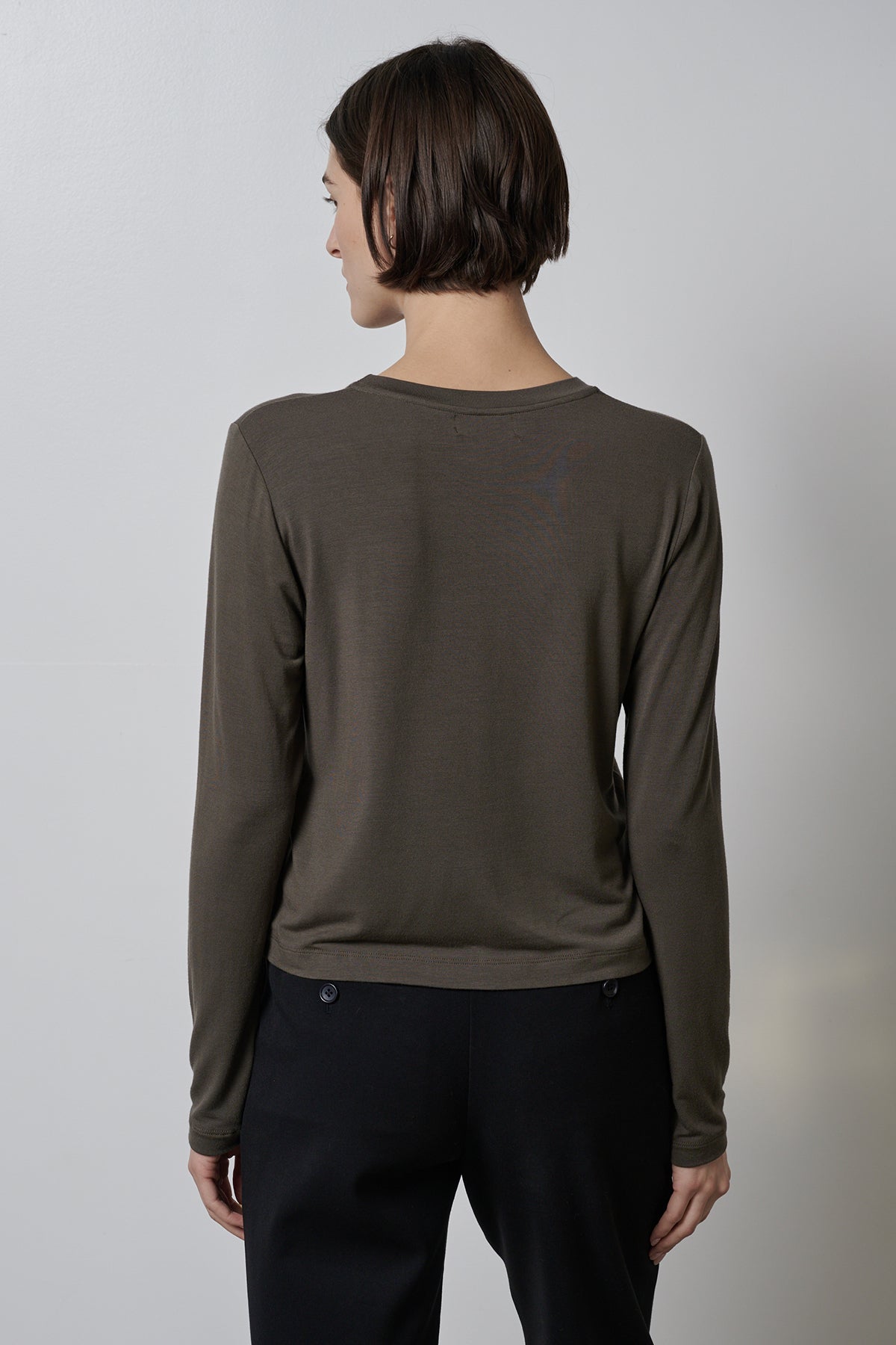 The back view of a woman wearing a Velvet by Jenny Graham PACIFICA TEE in olive.-35416710217921