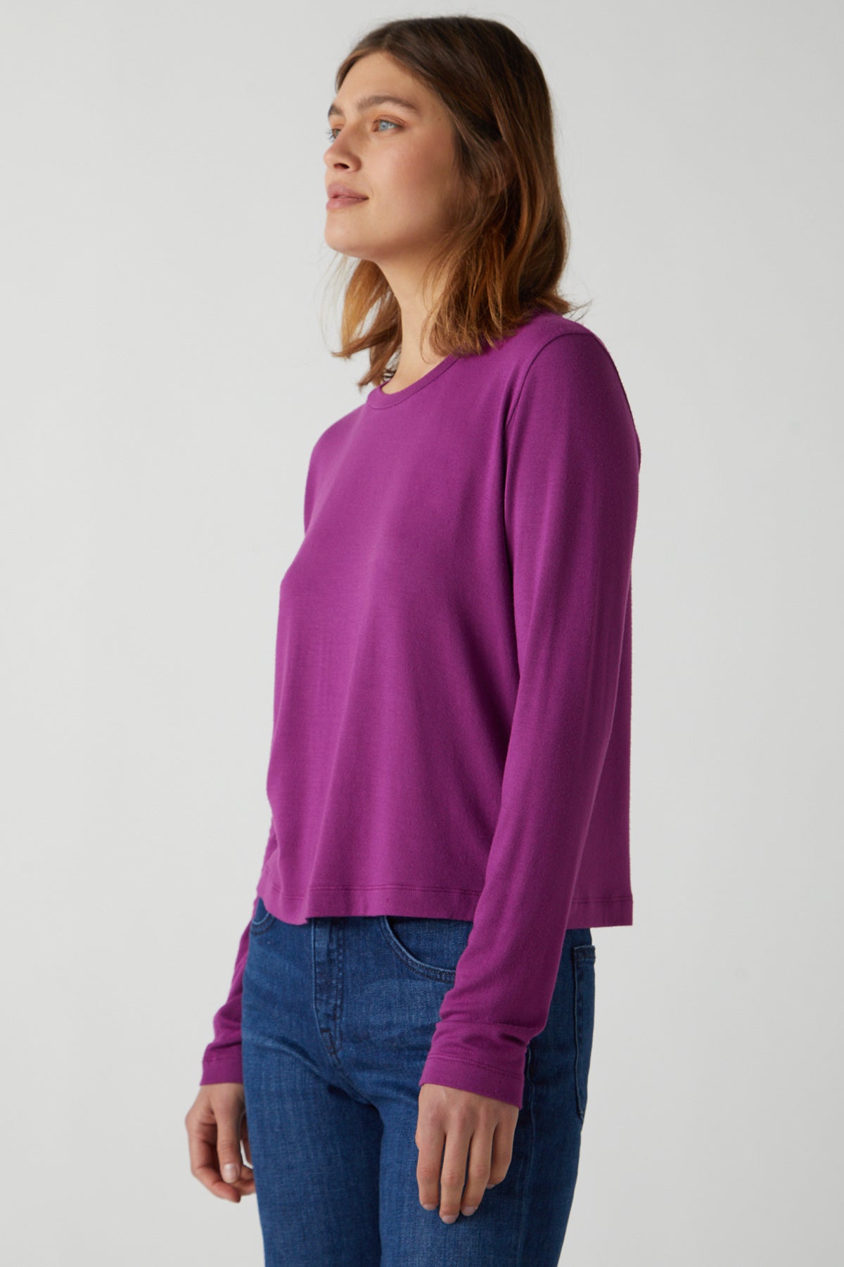   A woman wearing a Velvet by Jenny Graham rib knit, long-sleeved Pacifica Tee and stretch jeans. 