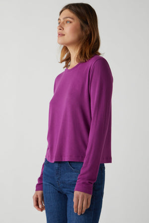 A woman wearing a Velvet by Jenny Graham rib knit, long-sleeved Pacifica Tee and stretch jeans.