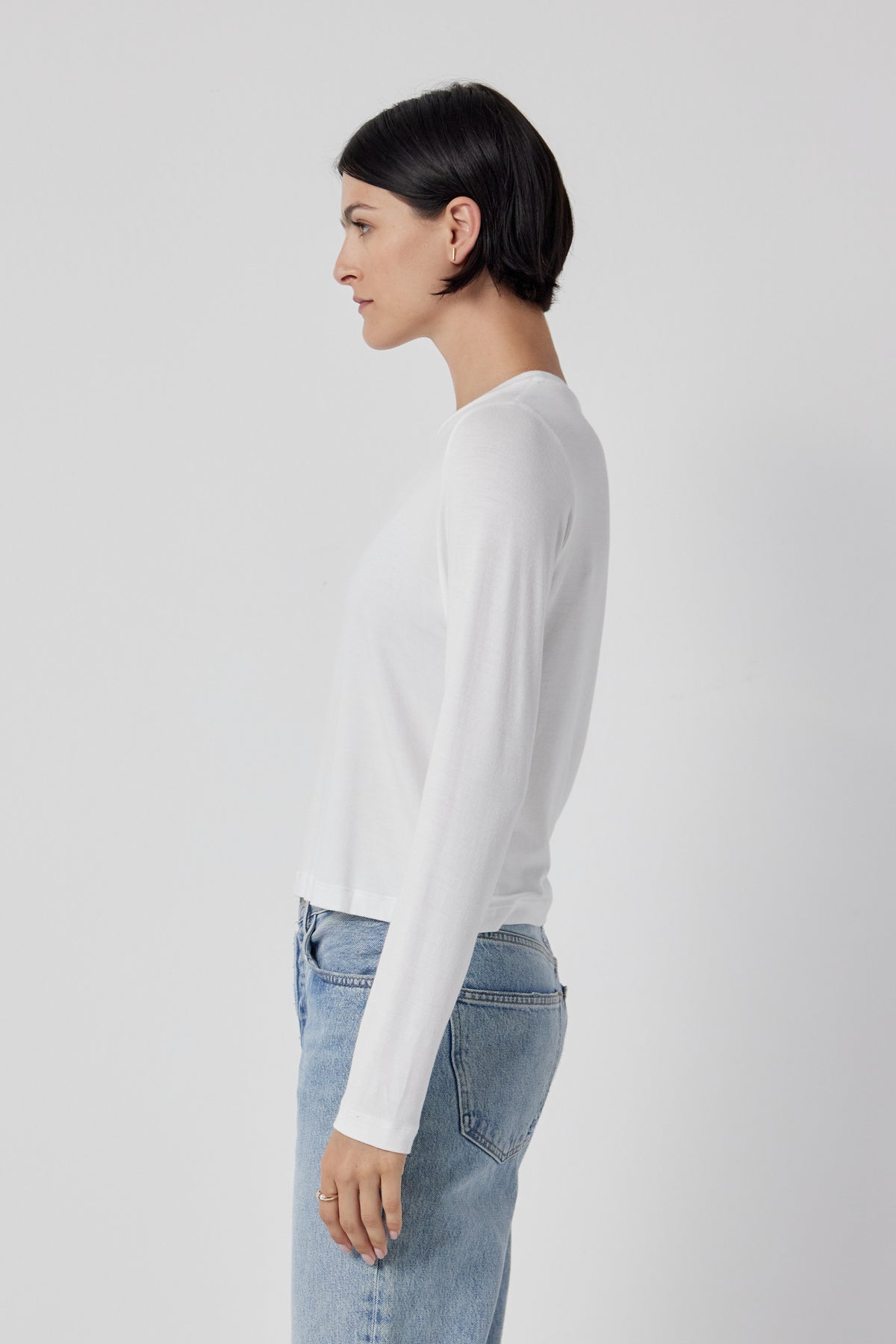 The back view of a woman wearing Velvet by Jenny Graham stretch jeans and a white long sleeved Pacifica Tee.-35416710643905