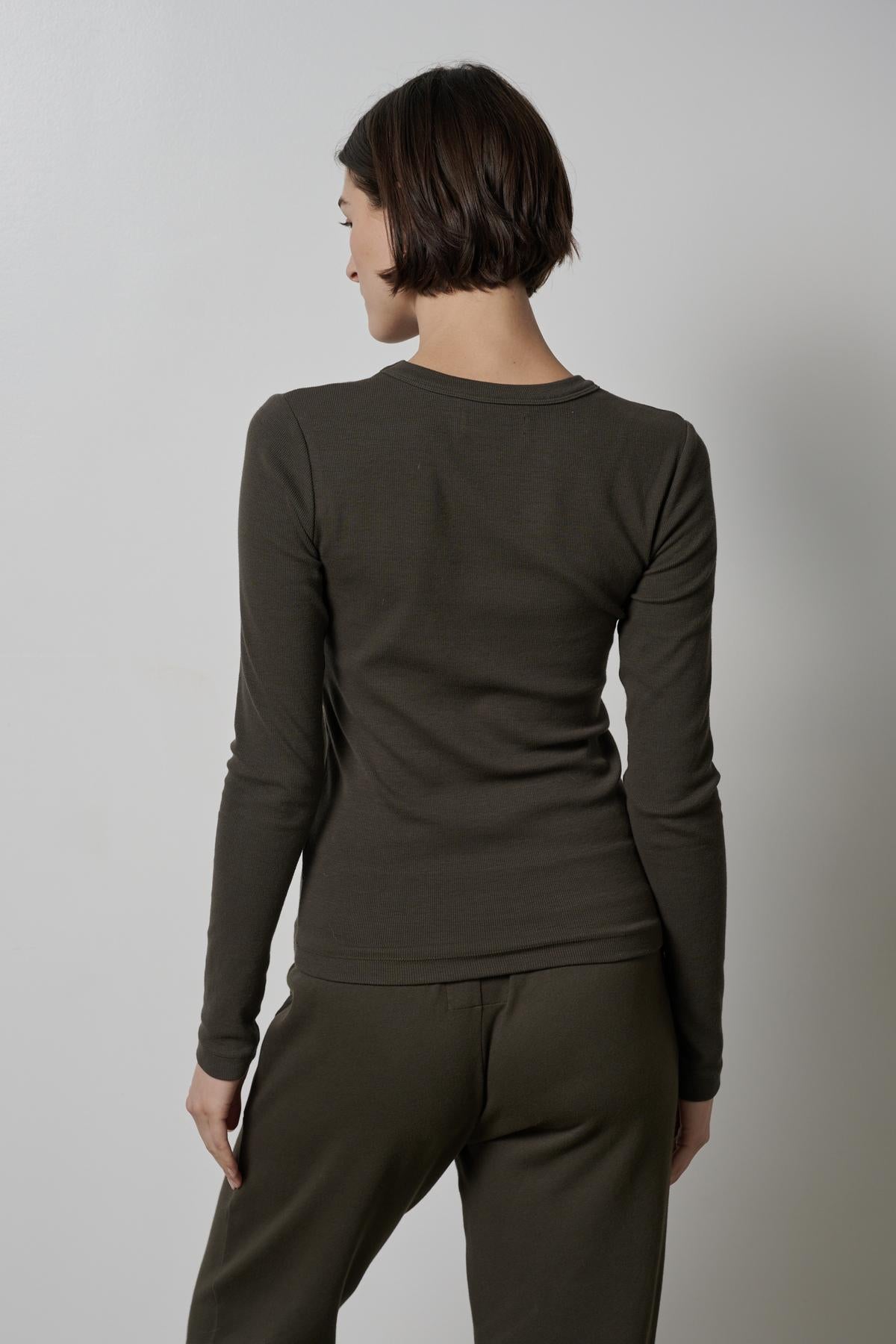   The back view of a woman wearing an Olive Camino Tee by Velvet by Jenny Graham. 
