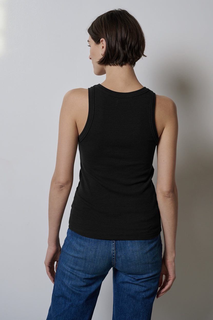 The woman's back reveals the stretch of her jeans and the weight of her Velvet by Jenny Graham CRUZ TANK TOP.