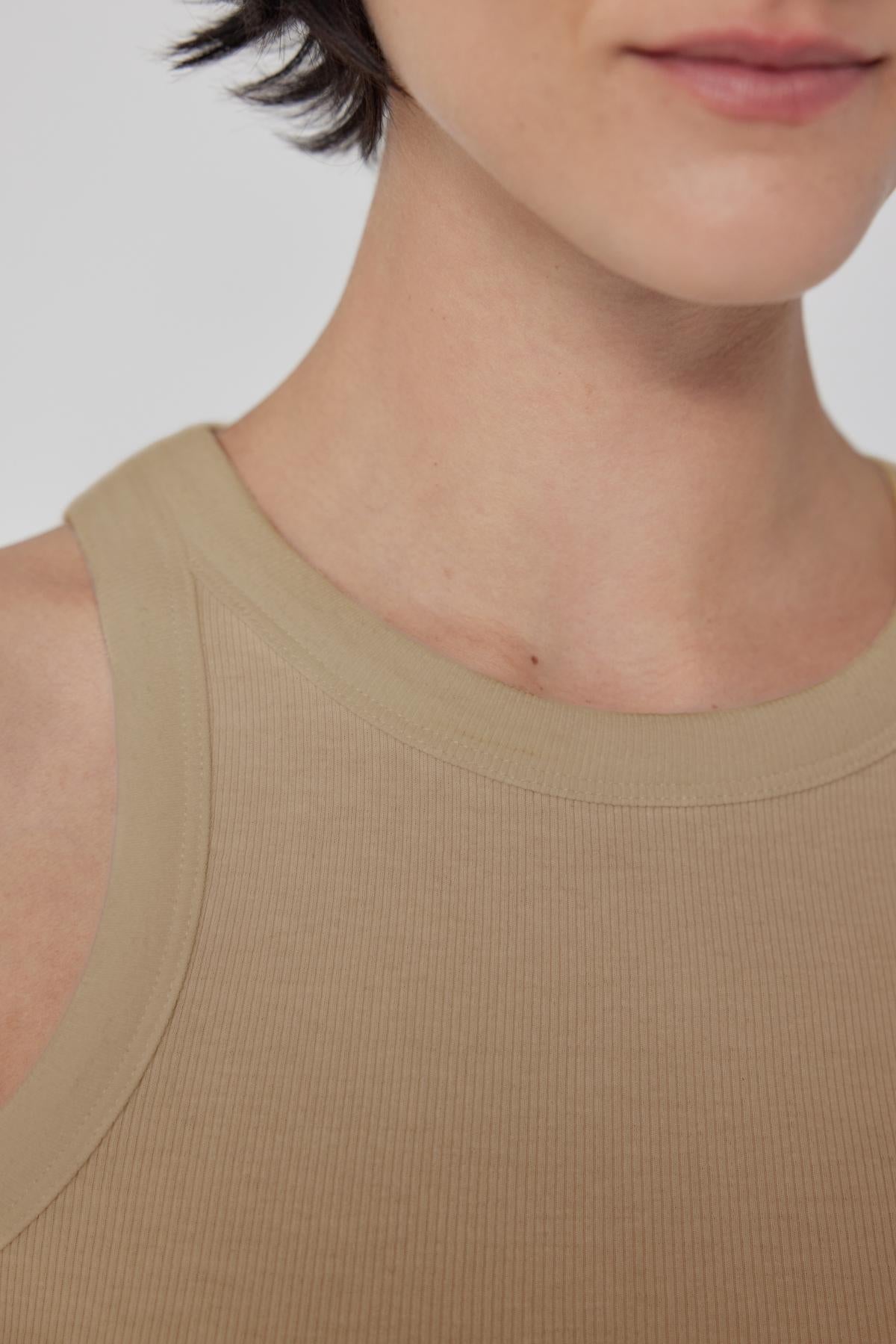Close-up of a person wearing a Velvet by Jenny Graham CRUZ tank top, showing the shoulder and neckline.-36463435317441
