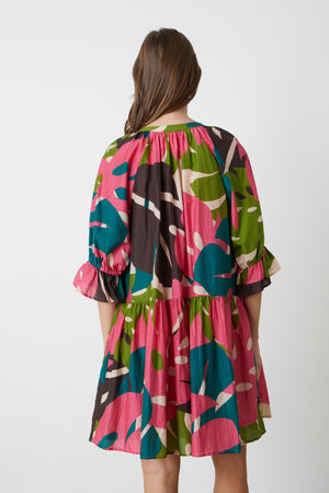 The back view of a woman wearing a Velvet by Graham & Spencer Tracy printed dress.