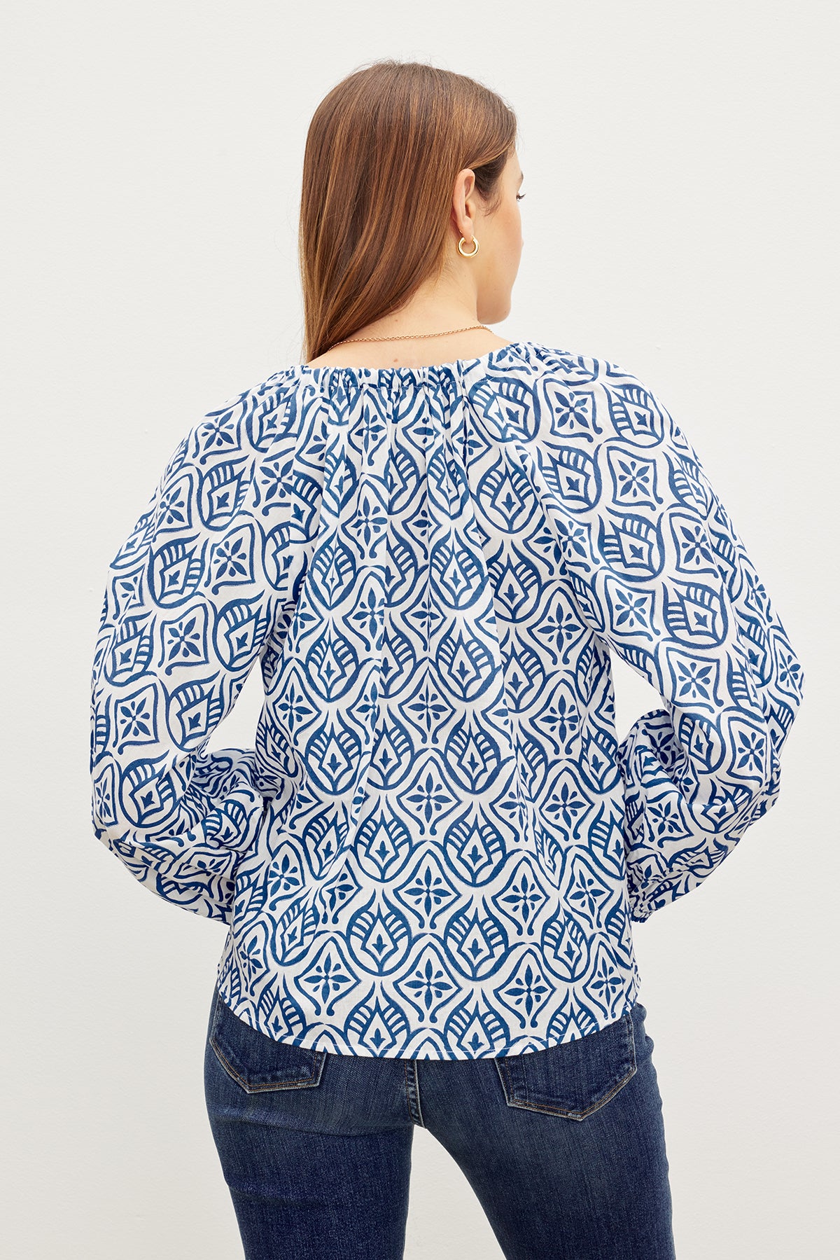   The back view of a woman wearing a Velvet by Graham & Spencer MARIAN PRINTED BUTTON FRONT TOP. 