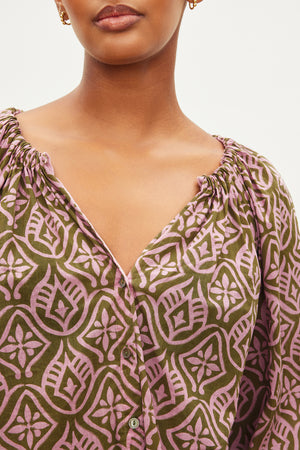 A woman wearing a Velvet by Graham & Spencer Marian printed button front top cotton blouse.