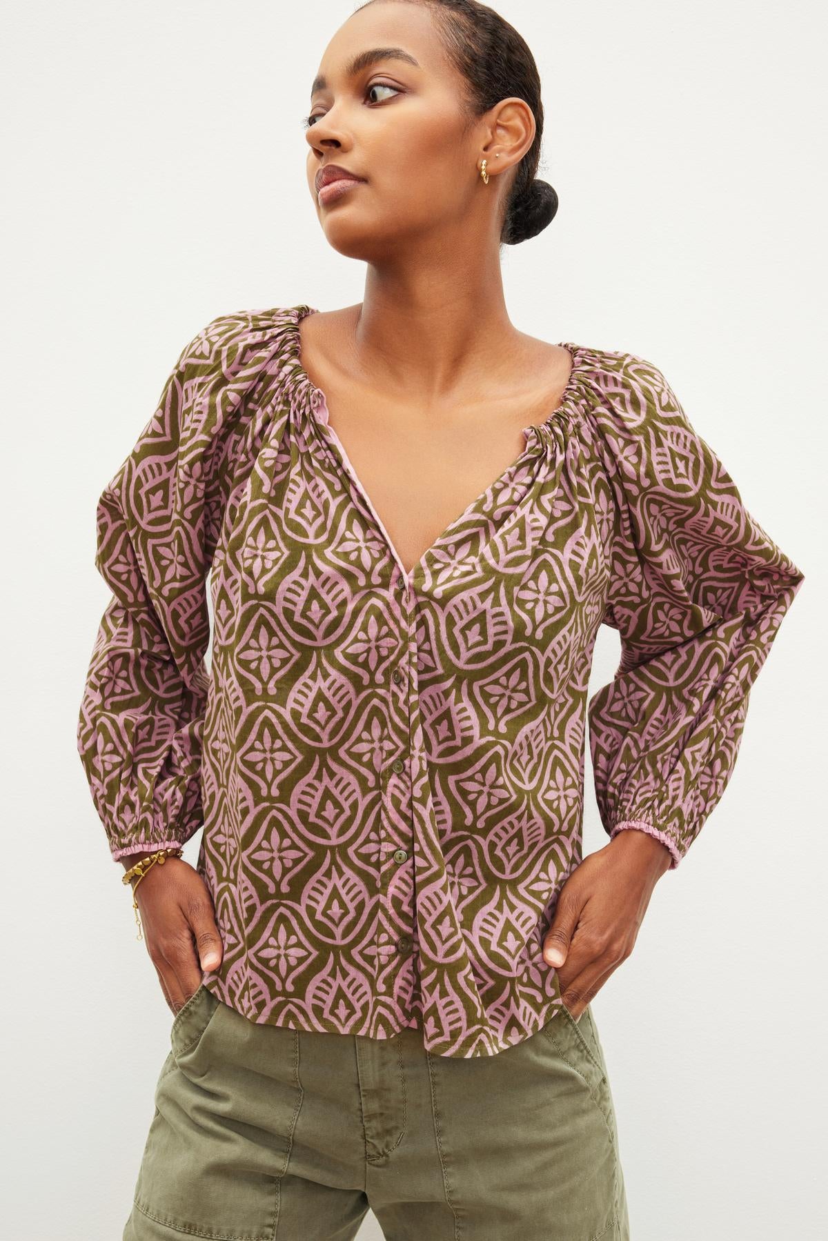 The model is wearing a chic ensemble - a Velvet by Graham & Spencer MARIAN PRINTED BUTTON FRONT TOP.-36040414920897