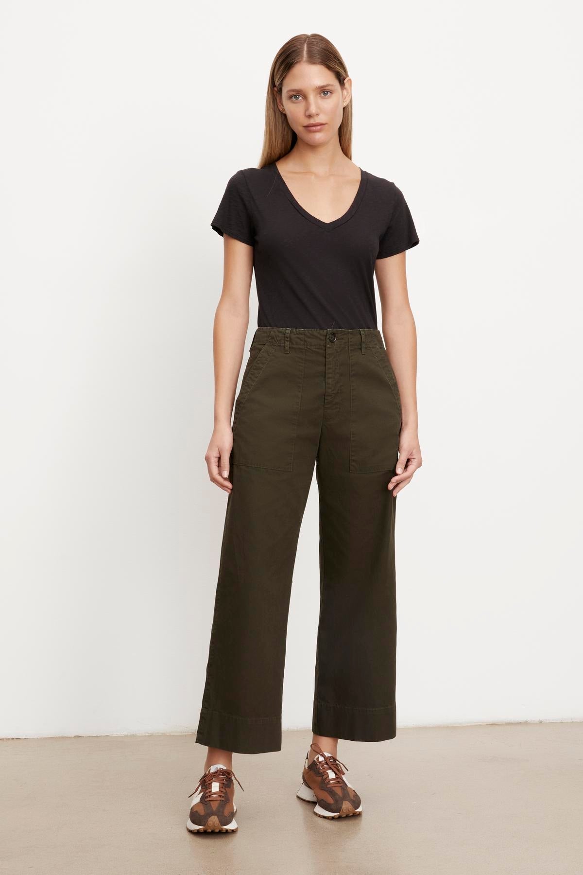   A person wearing a Velvet by Graham & Spencer slim top and Velvet by Graham & Spencer cropped trousers in olive green. 
