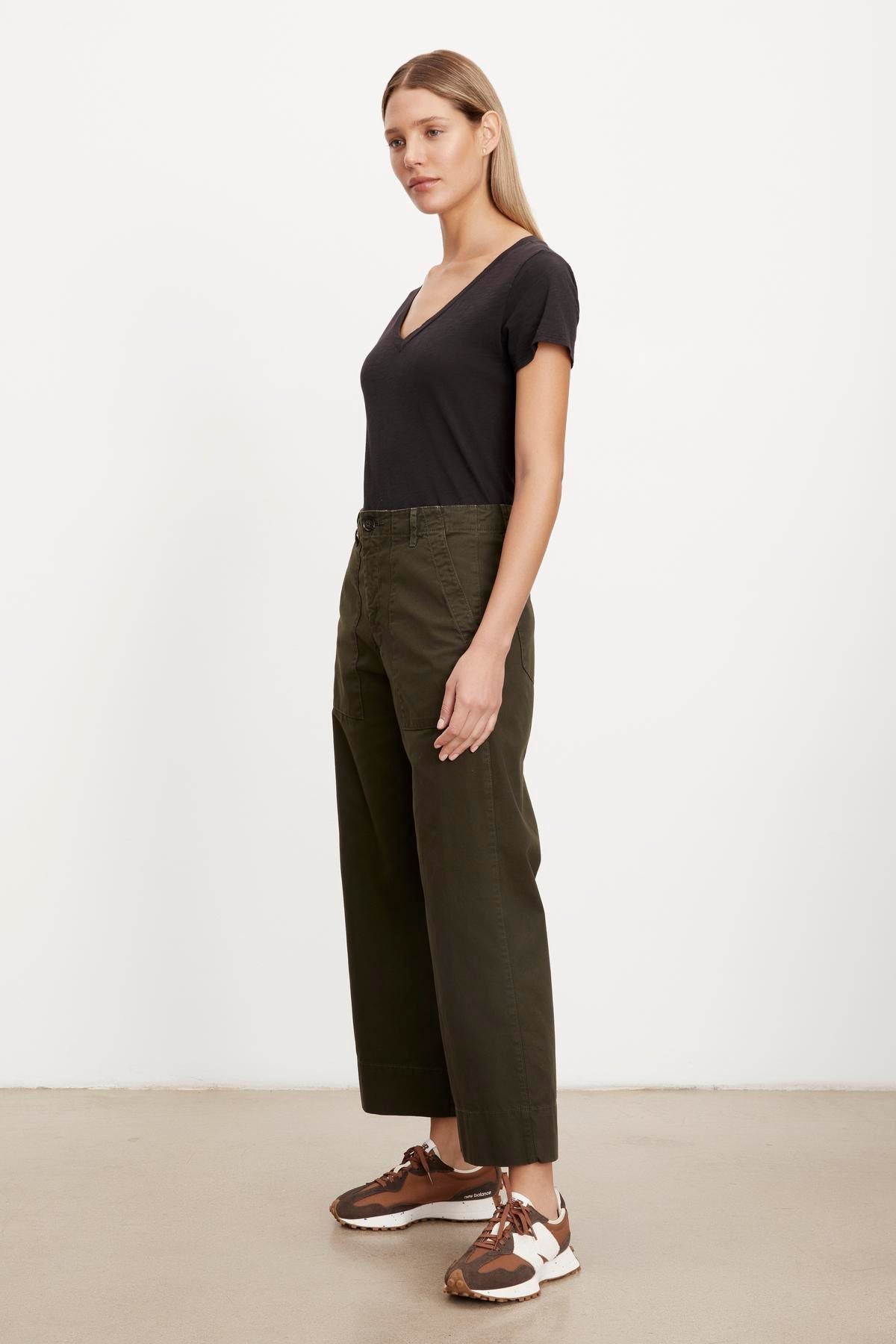 The model is wearing a slim top and MYA COTTON CANVAS PANT trousers in olive green from Velvet by Graham & Spencer.-36320657146049