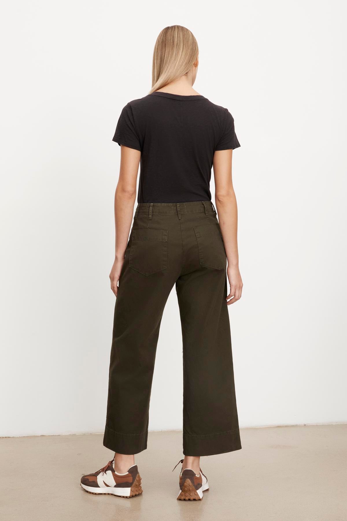 The back view of a woman wearing Velvet by Graham & Spencer's MYA COTTON CANVAS PANT in olive green cropped trousers.-36320657178817